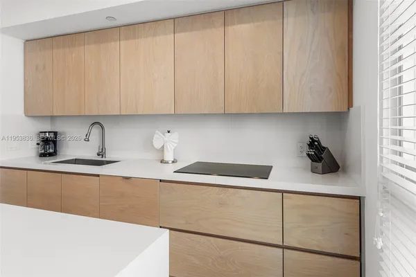 a kitchen with a sink a cabinets and appliances