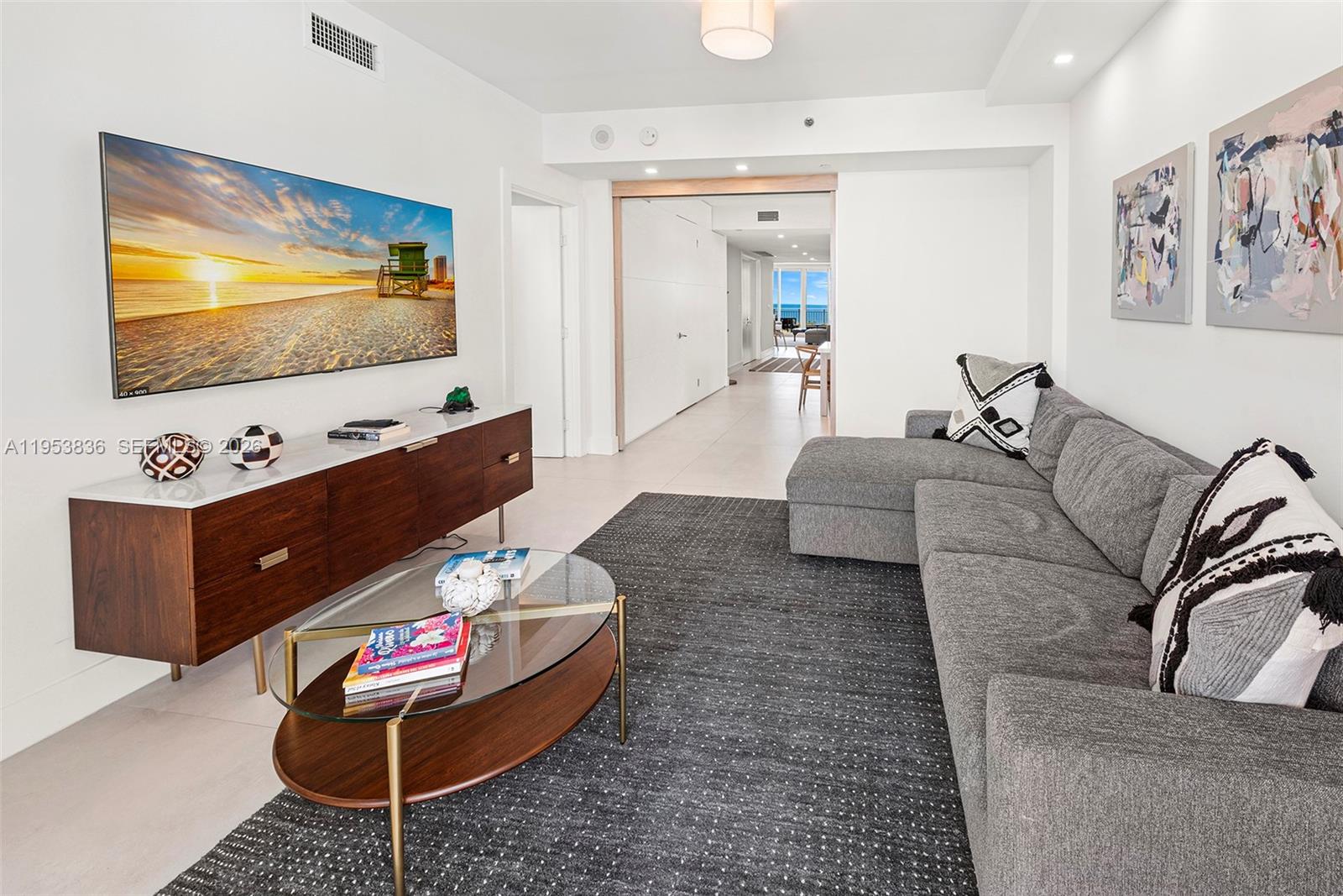 791 Crandon Boulevard, Unit 901 Key Biscayne, FL 33149 - Photo 17 of 43 a living room with furniture and a flat screen tv