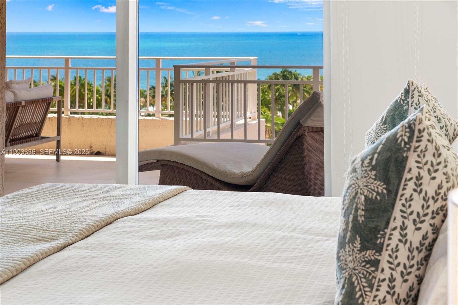 791 Crandon Boulevard, Unit 901 Key Biscayne, FL 33149 - Photo 24 of 43 a large bedroom with a bed and balcony view