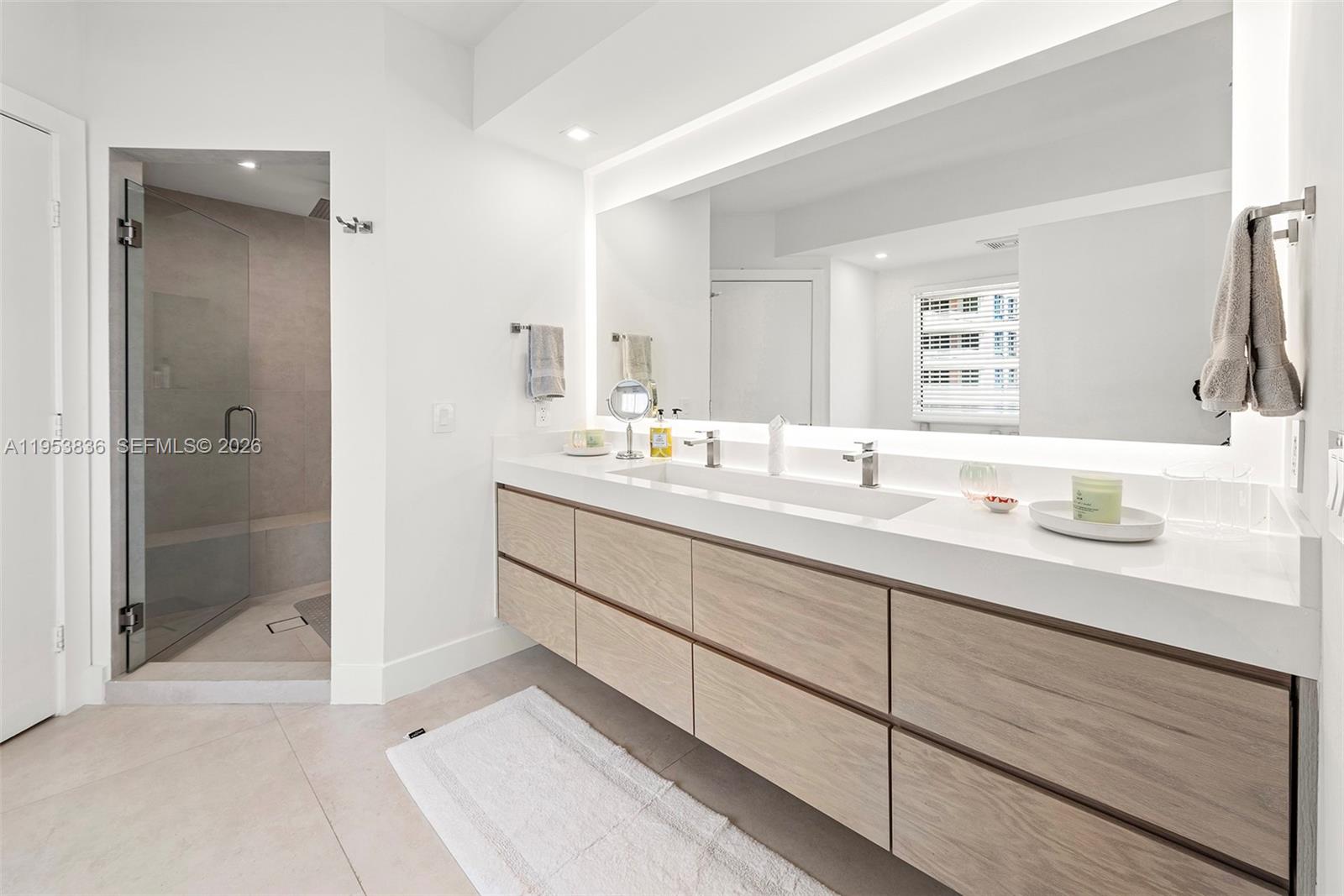 791 Crandon Boulevard, Unit 901 Key Biscayne, FL 33149 - Photo 26 of 43 a bathroom with a sink double vanity and a shower