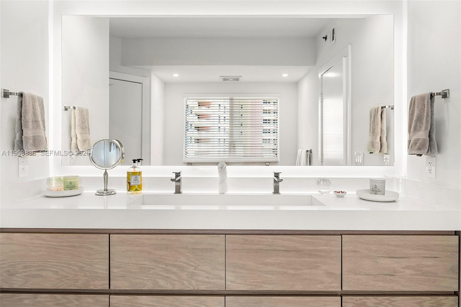 791 Crandon Boulevard, Unit 901 Key Biscayne, FL 33149 - Photo 27 of 43 a bathroom with a sink and a mirror