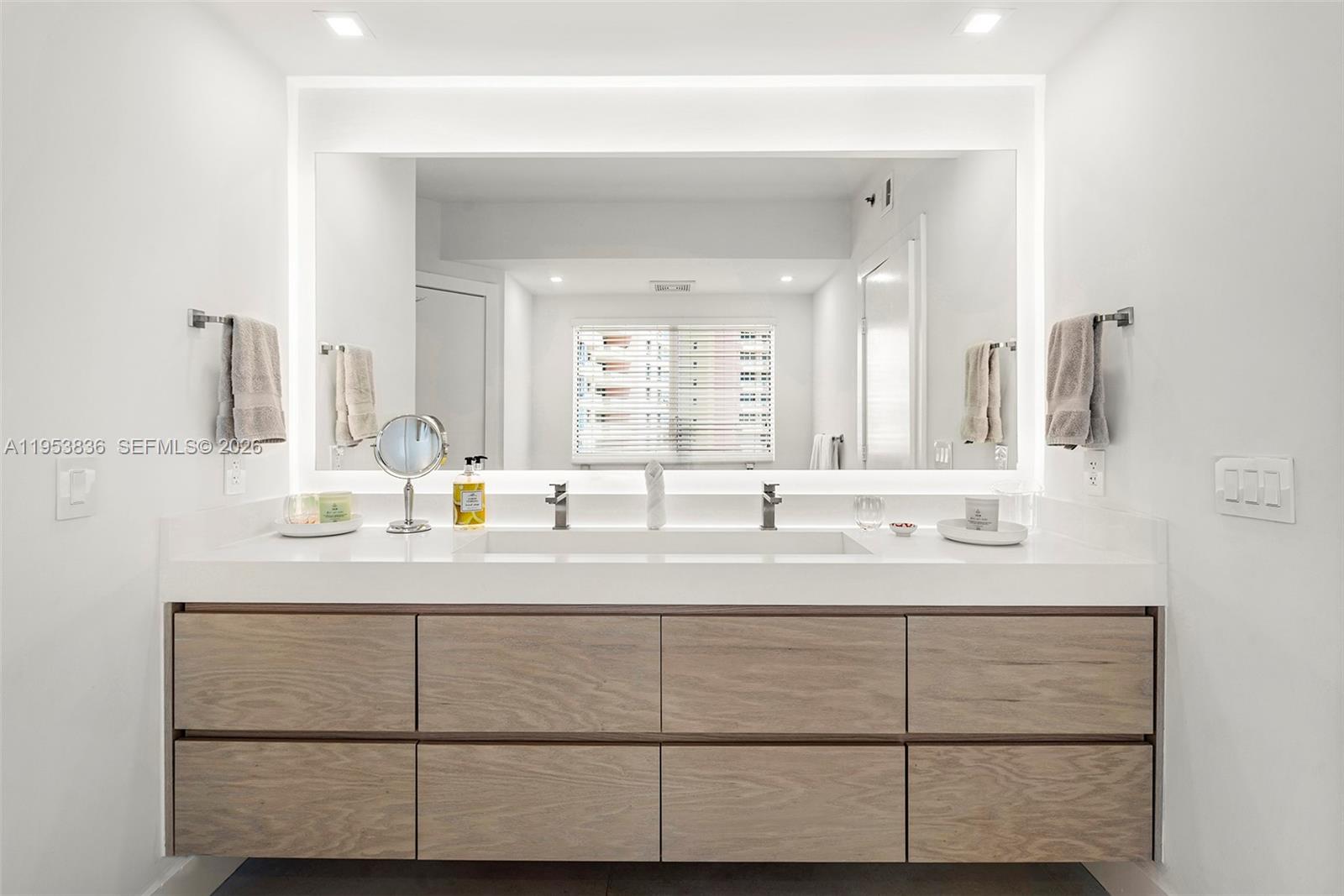 791 Crandon Boulevard, Unit 901 Key Biscayne, FL 33149 - Photo 28 of 43 a bathroom with a sink and a mirror