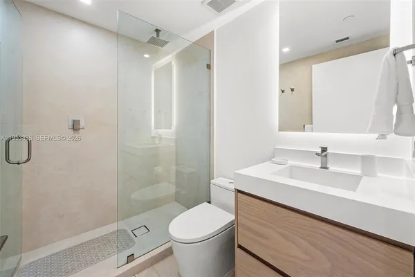 a bathroom with a sink toilet and shower