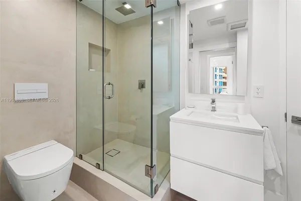 a bathroom with a shower a toilet and sink