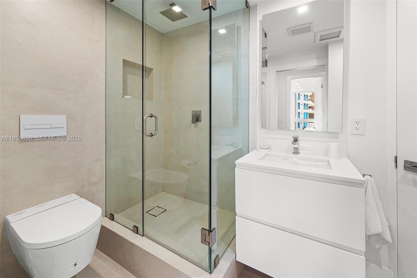 791 Crandon Boulevard, Unit 901 Key Biscayne, FL 33149 - Photo 40 of 43 a bathroom with a shower a toilet and sink