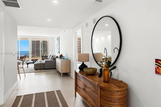 a living room with furniture and a mirror