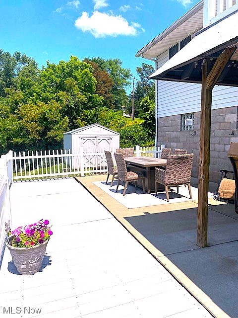 68960 Pine Terrace Road Bridgeport, OH 43912 - Photo 29 of 32 View of patio / terrace featuring a wooden deck, outdoor dining space, a storage unit, and a gazebo