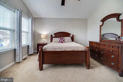 a bedroom with a bed and dresser