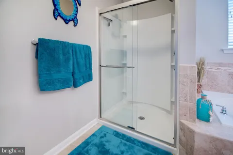 a view of walk in closet with clothes