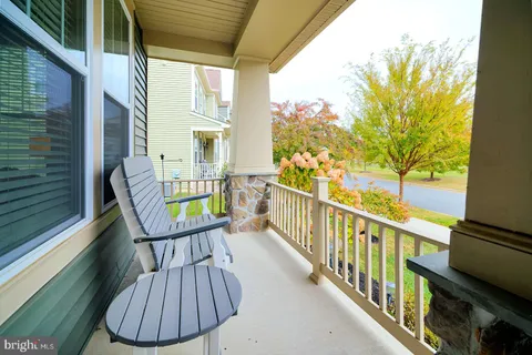 a dining room with furniture a chandelier and wooden floor