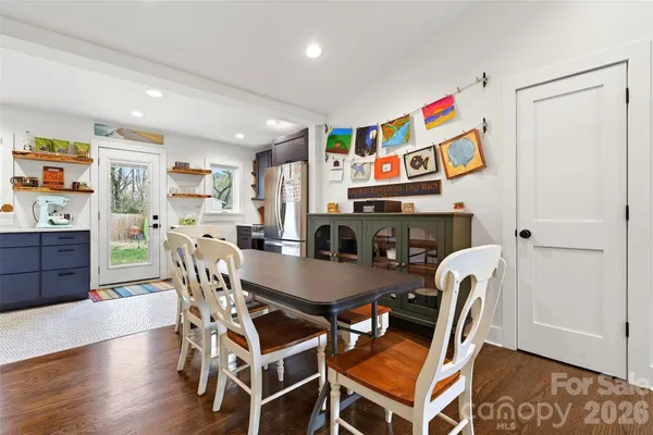 a dining room with furniture and wooden floor