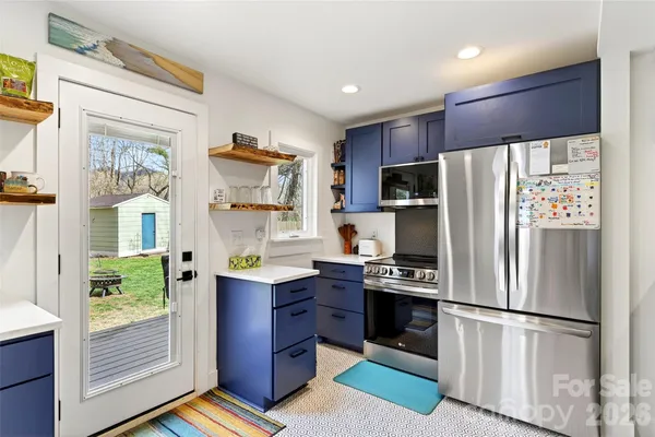 a kitchen with stainless steel appliances a refrigerator and a stove
