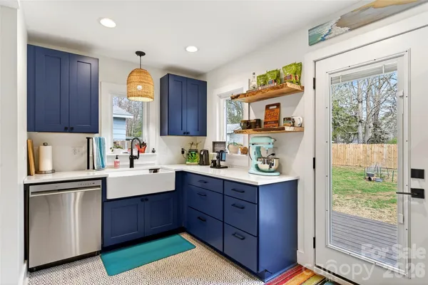 a kitchen with a sink a window and cabinets