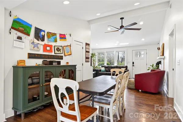 a view of a dining room with furniture and a chandelier
