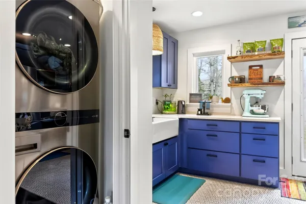 a hallway with a washer and dryer