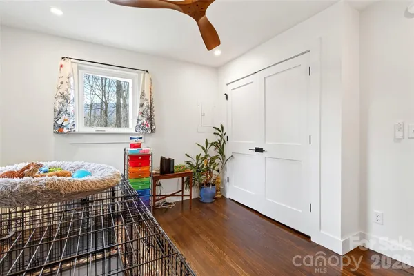 a hallway with furniture and wooden floor