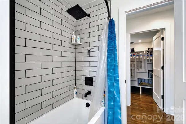 a bathroom with a bathtub and a shower