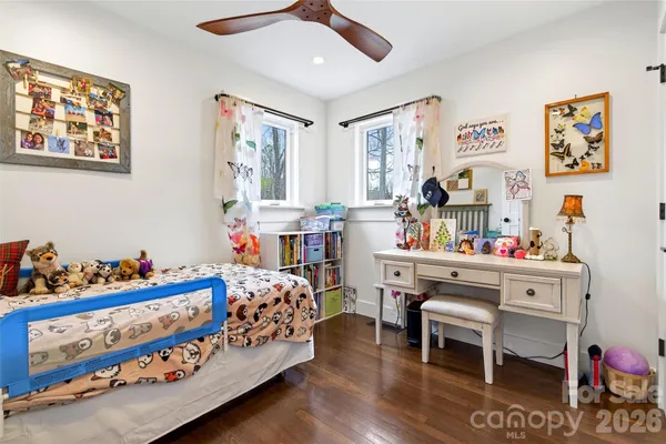 a bed room with furniture and a baby crib