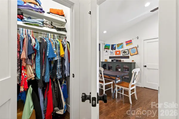 a view of walk in closet with clothes and shoes