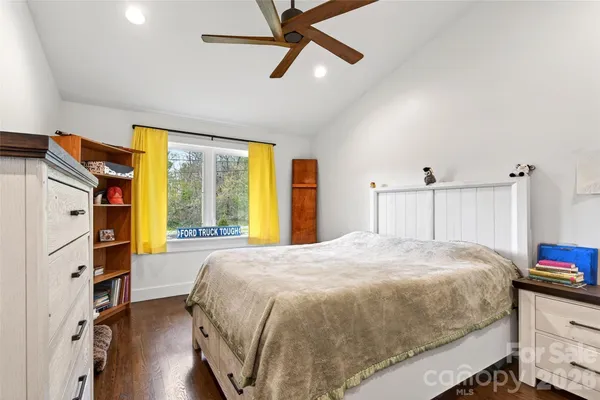 a spacious bedroom with a bed and a window