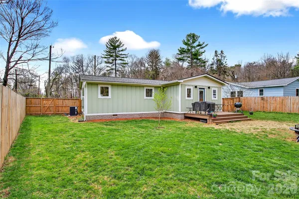 a view of a house with a yard and sitting area