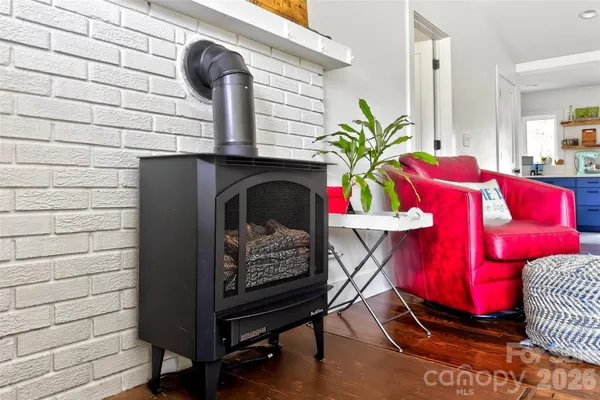 a view of living room with furniture and wooden floor