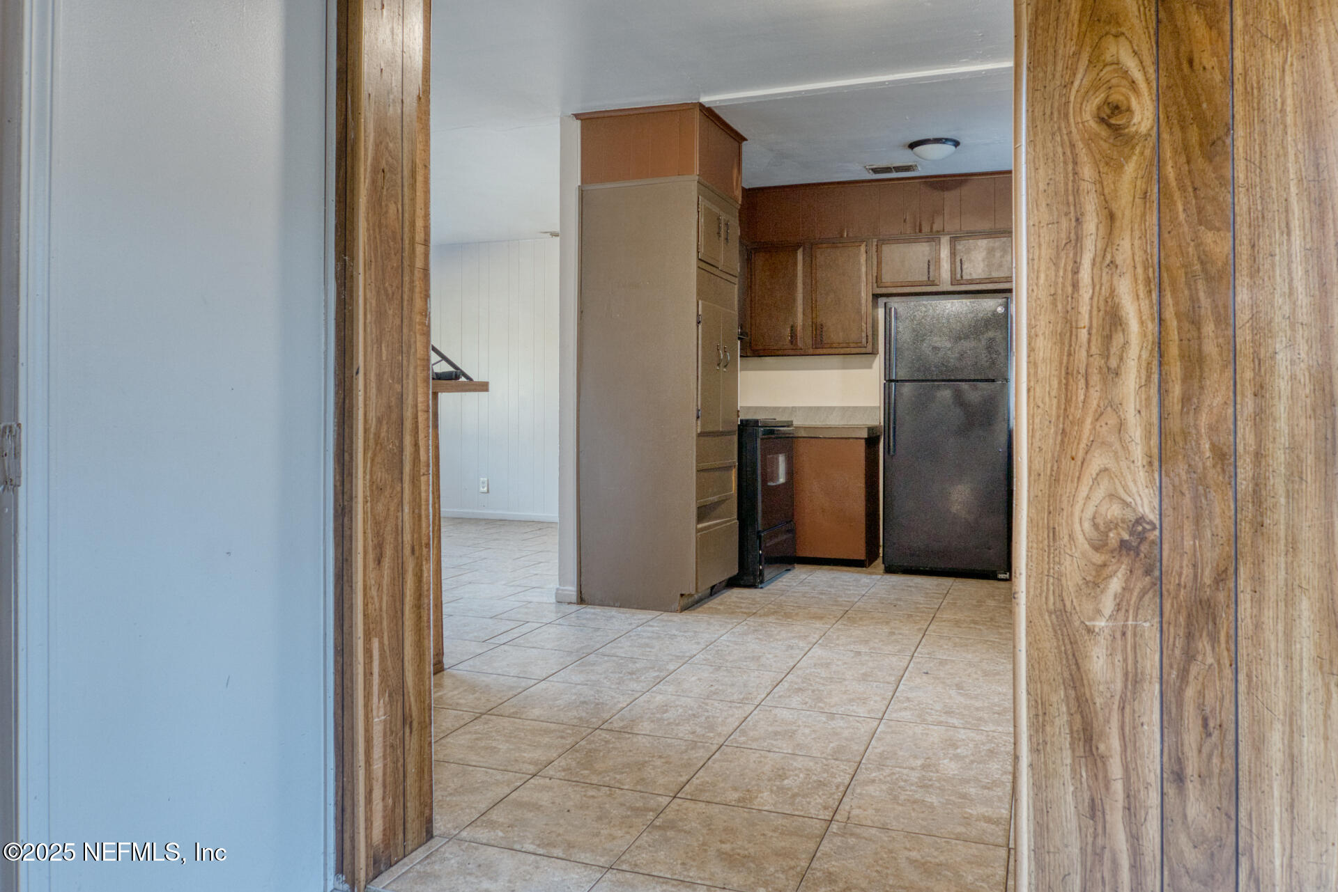 4828 Lambing Road Jacksonville, FL 32210 - Photo 11 of 31 a view of a kitchen with refrigerator and a sink