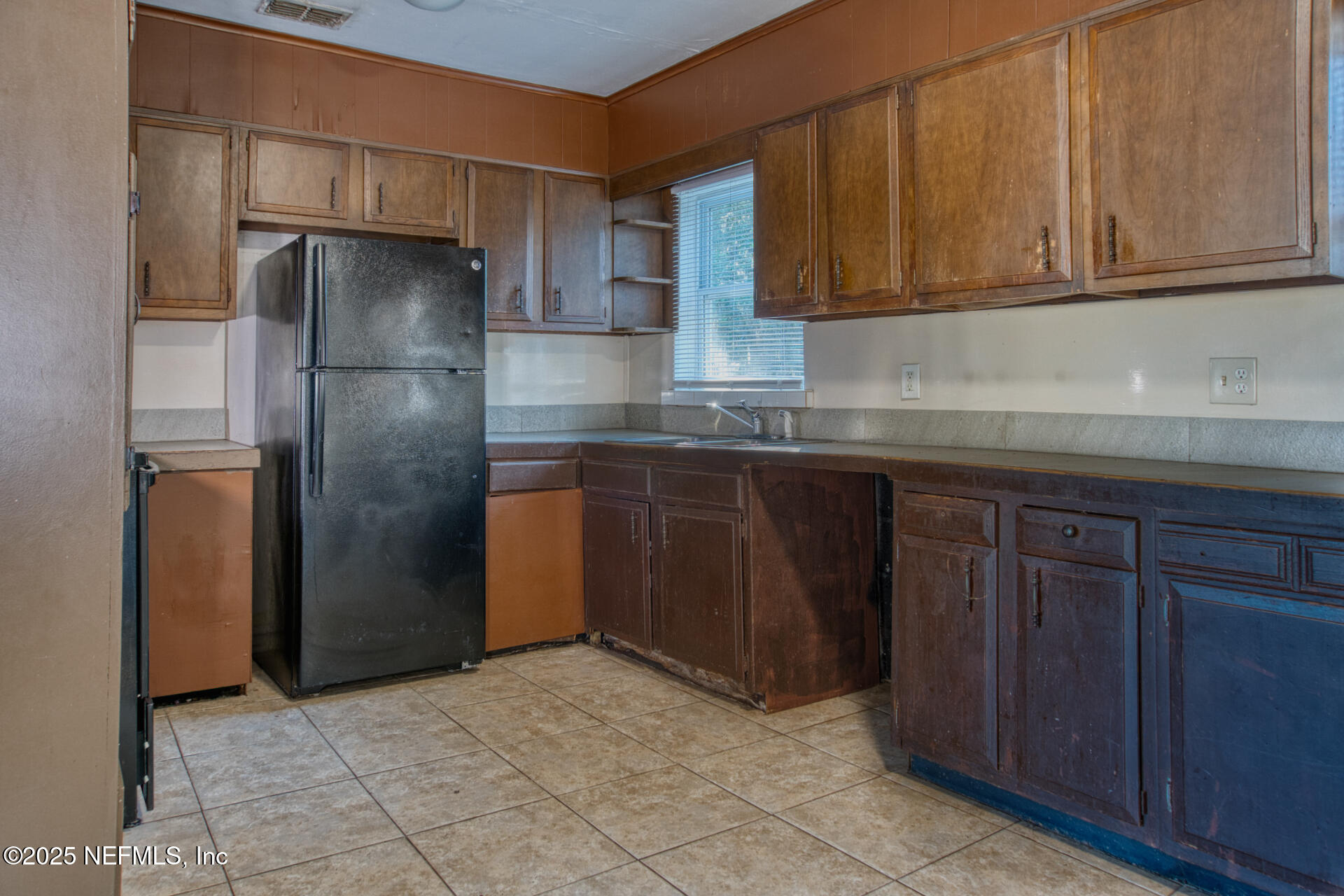 4828 Lambing Road Jacksonville, FL 32210 - Photo 12 of 31 a kitchen with stainless steel appliances granite countertop a refrigerator and a sink