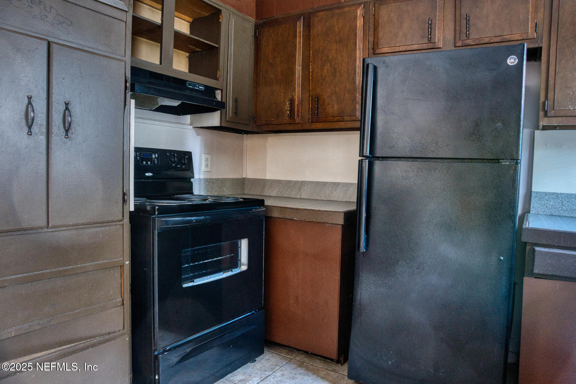 4828 Lambing Road Jacksonville, FL 32210 - Photo 13 of 31 a kitchen with stainless steel appliances granite countertop a refrigerator and a stove top oven