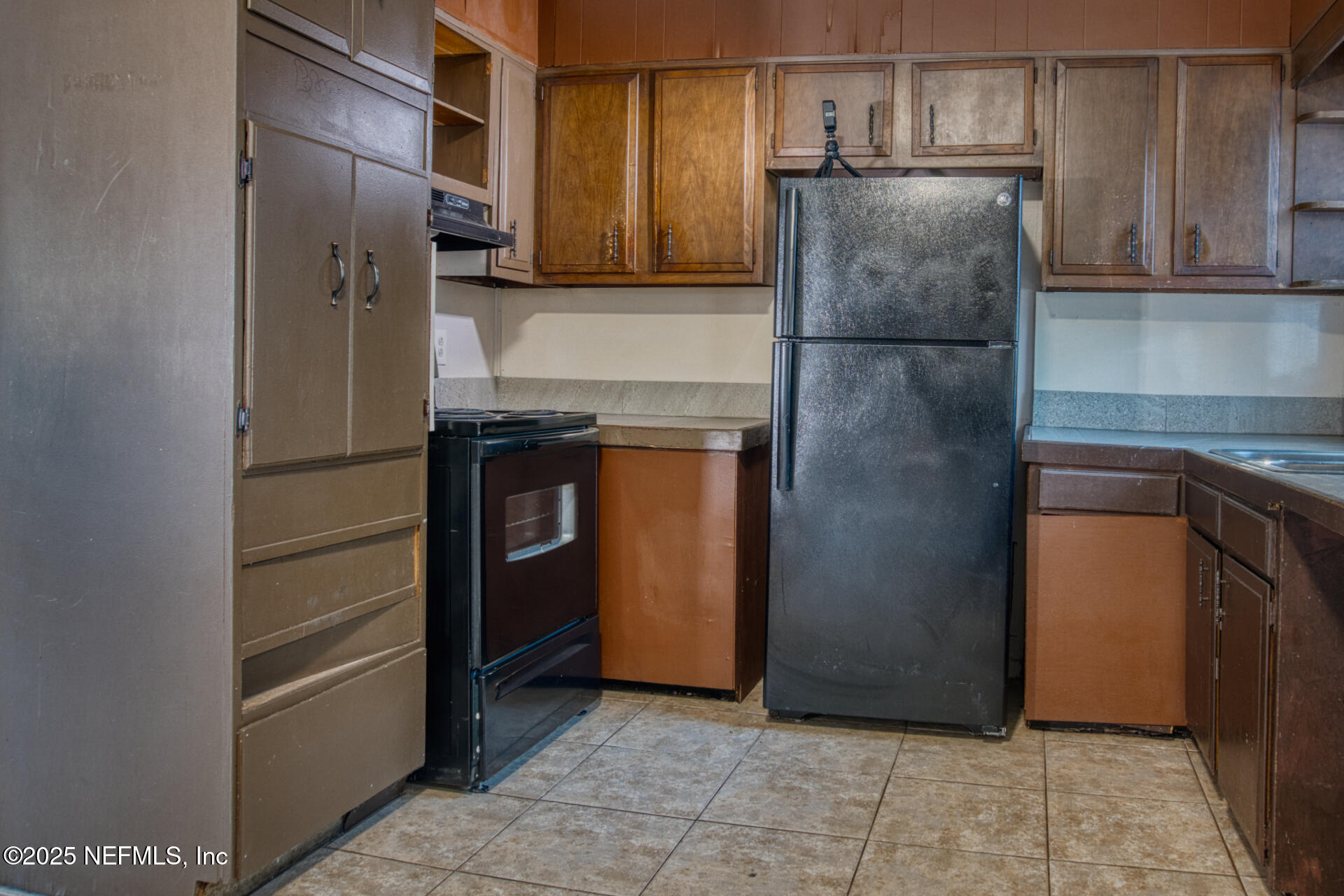 4828 Lambing Road Jacksonville, FL 32210 - Photo 14 of 31 a kitchen with stainless steel appliances granite countertop a refrigerator and a sink