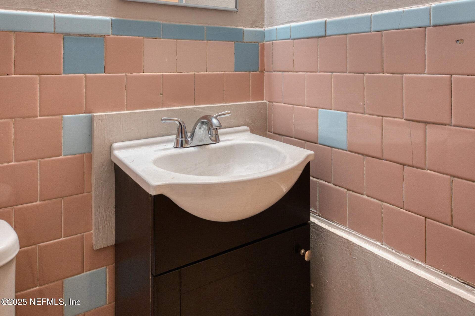 4828 Lambing Road Jacksonville, FL 32210 - Photo 20 of 31 a bathroom with a sink and a mirror