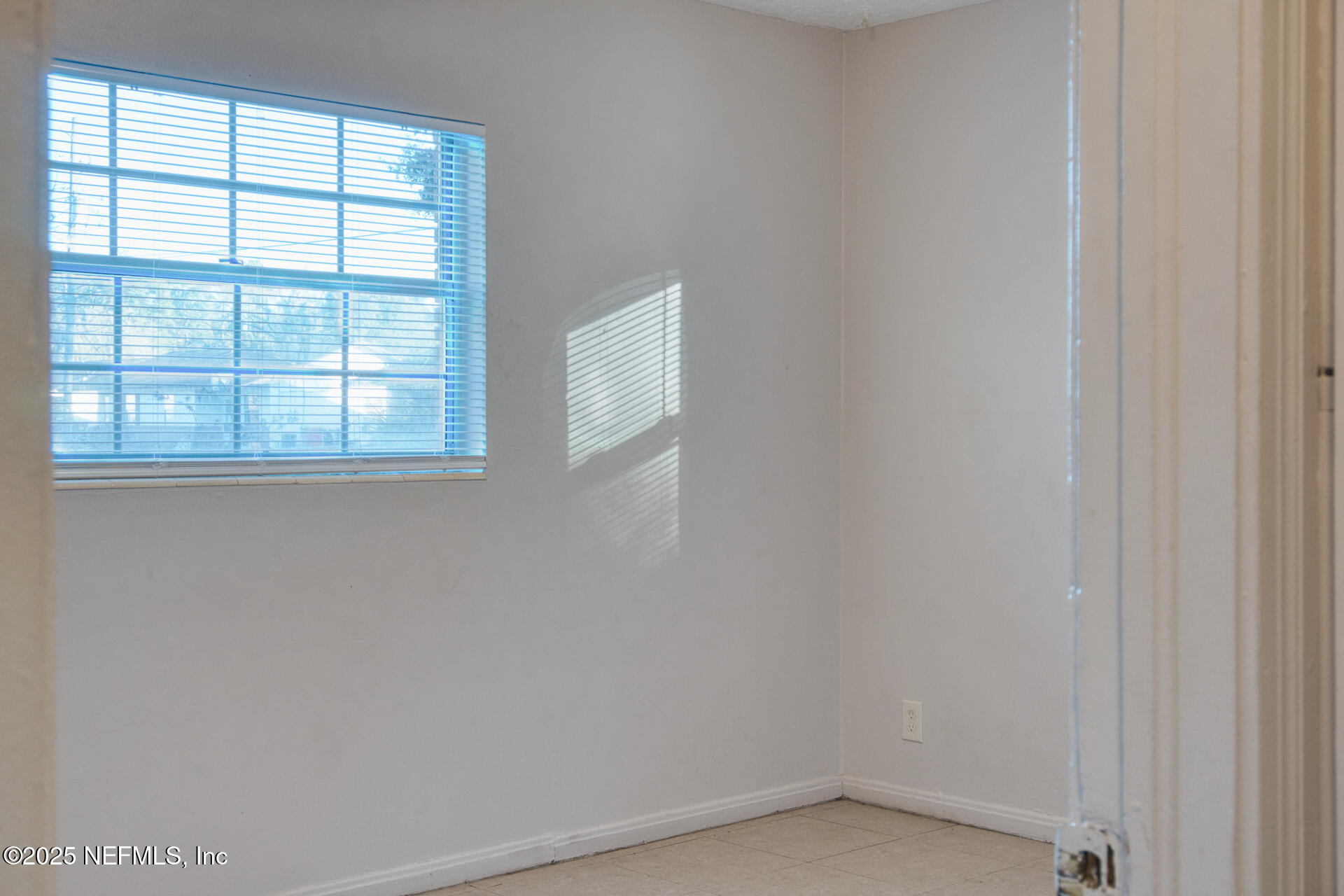 4828 Lambing Road Jacksonville, FL 32210 - Photo 22 of 31 an empty room with a window