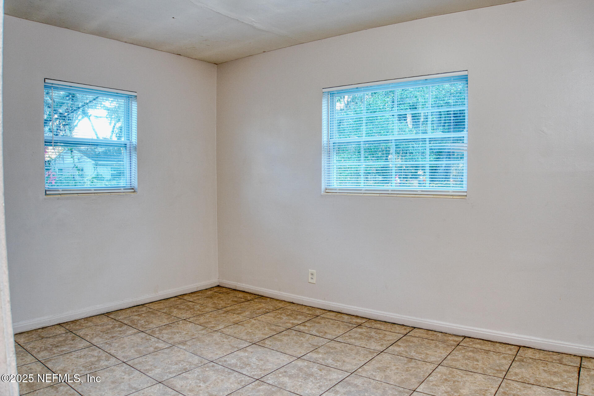 4828 Lambing Road Jacksonville, FL 32210 - Photo 24 of 31 an empty room with windows