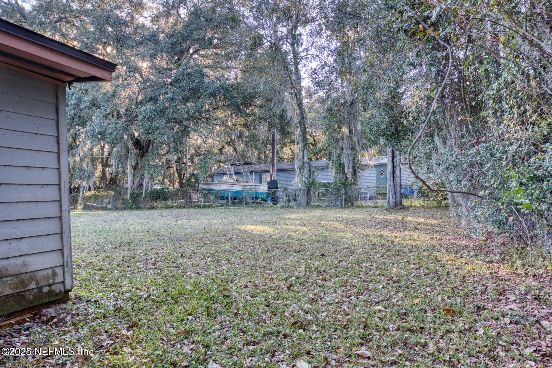 4828 Lambing Road Jacksonville, FL 32210 - Photo 3 of 31 a backyard of a house with lots of green space