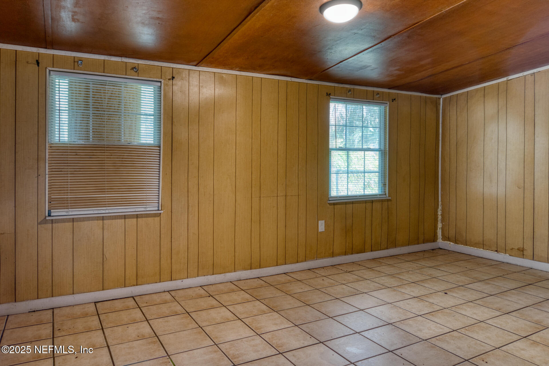 4828 Lambing Road Jacksonville, FL 32210 - Photo 7 of 31 a view of an empty room with wooden floor
