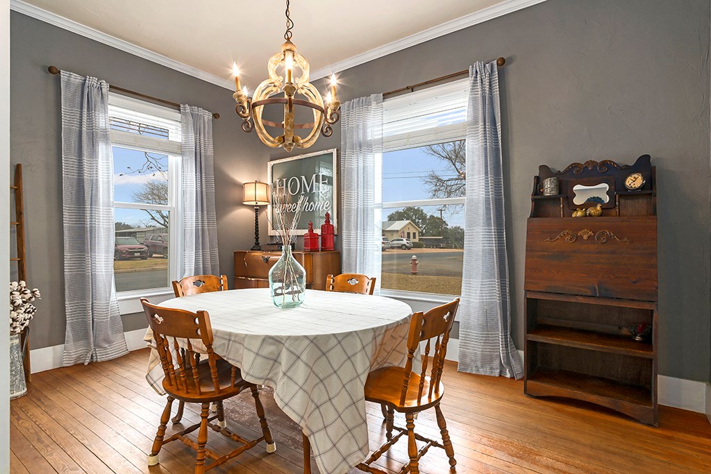 601 Bell Street Fredericksburg, TX 78624 - Photo 13 of 39 a dining room with furniture wooden floor and a chandelier