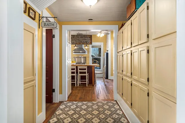 a hallway with wooden floor and furniture