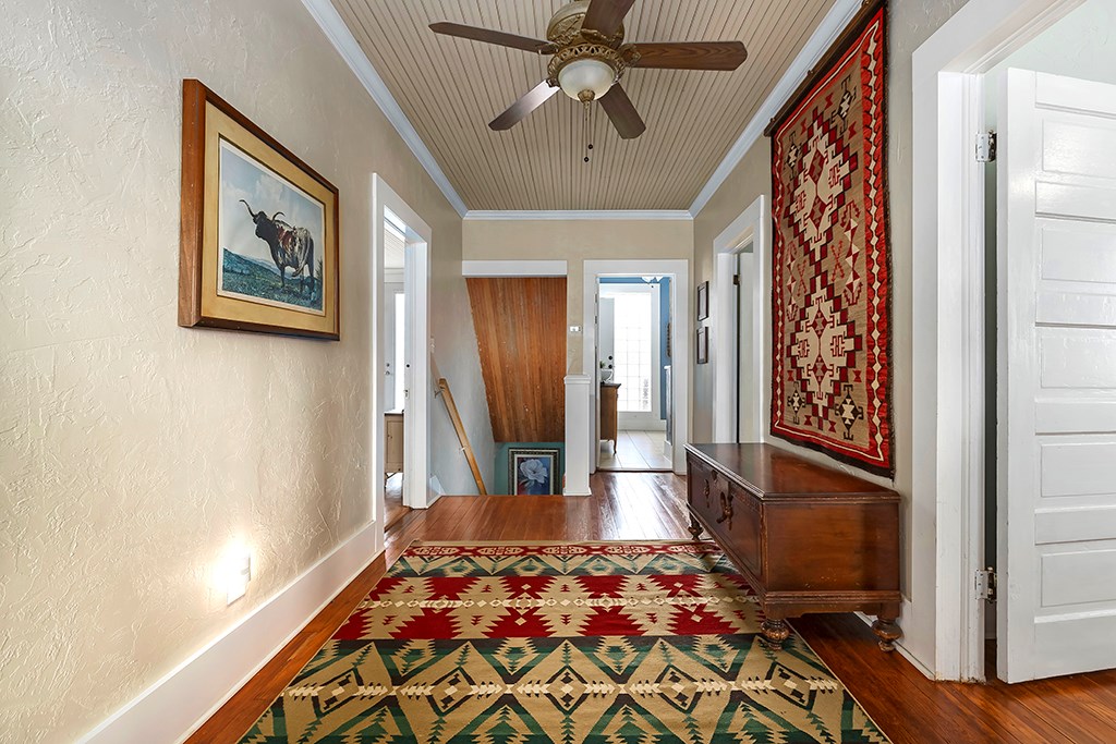 601 Bell Street Fredericksburg, TX 78624 - Photo 15 of 39 a bedroom with a bed and a chandelier