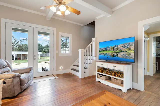 a view of a livingroom with furniture wooden floor and windows