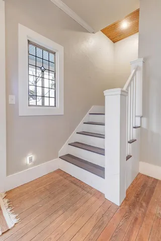a view of entryway and hall with wooden floor