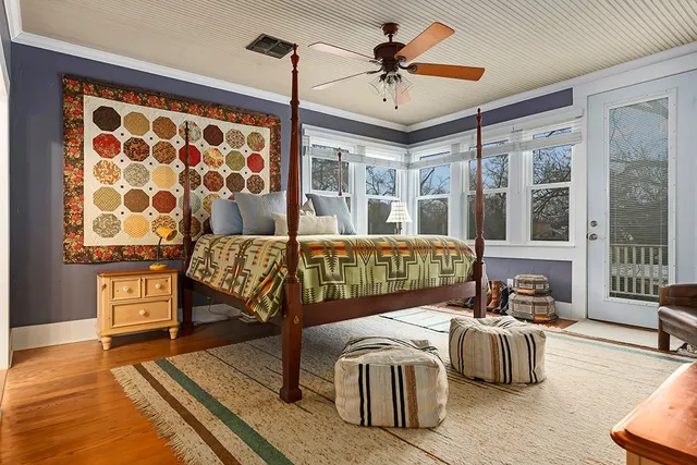 a bedroom with furniture and wooden floor
