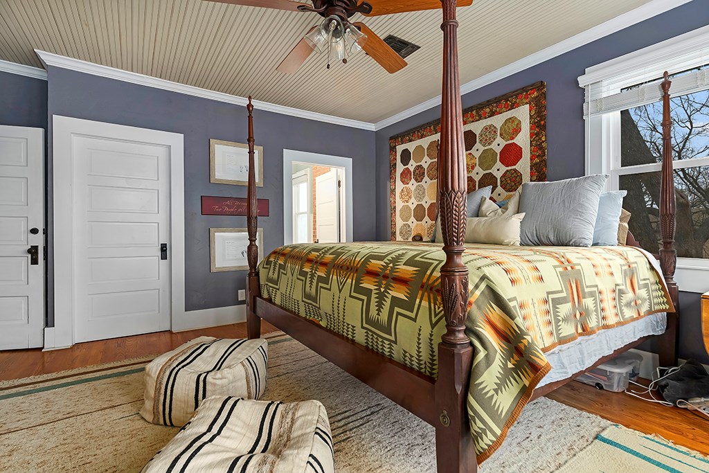 601 Bell Street Fredericksburg, TX 78624 - Photo 21 of 39 a bedroom with a large bed and a chandelier