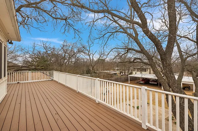 a view of balcony with wooden floor and fence
