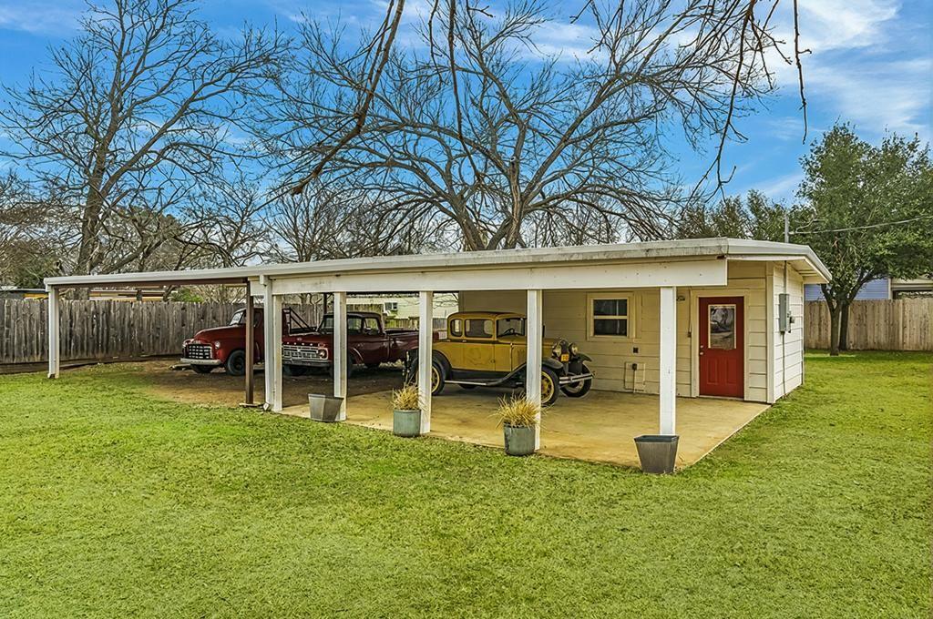601 Bell Street Fredericksburg, TX 78624 - Photo 35 of 39 a view of a house with a yard and large tree