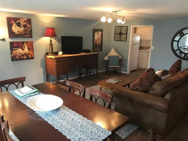 a view of a dining room with furniture and chandelier