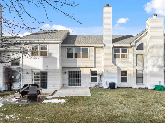 a view of a house with backyard and sitting area