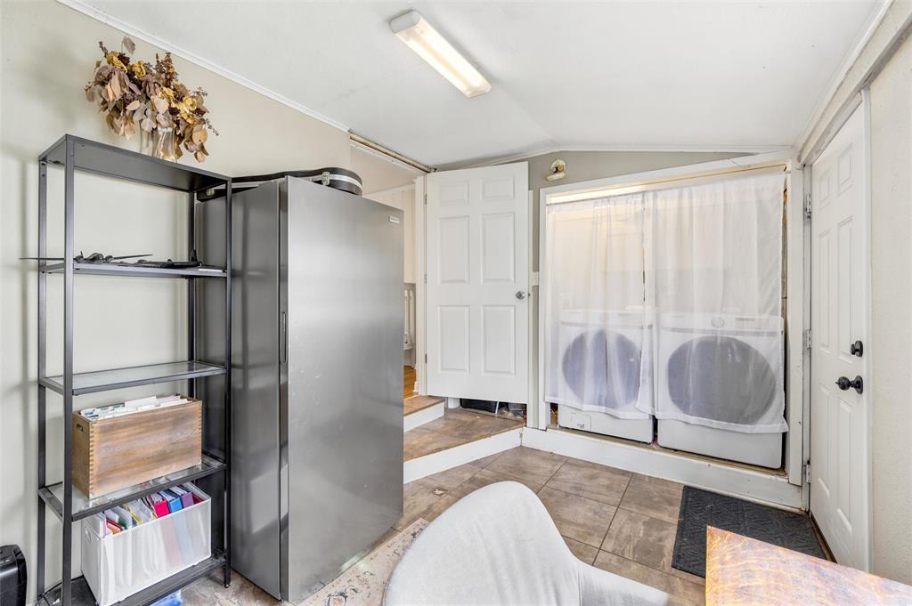 3012 Mitchell Avenue Waco, TX 76708 - Photo 12 of 18 Utility room featuring tile flooring, a built-in washer and dryer, and two solid panel doors