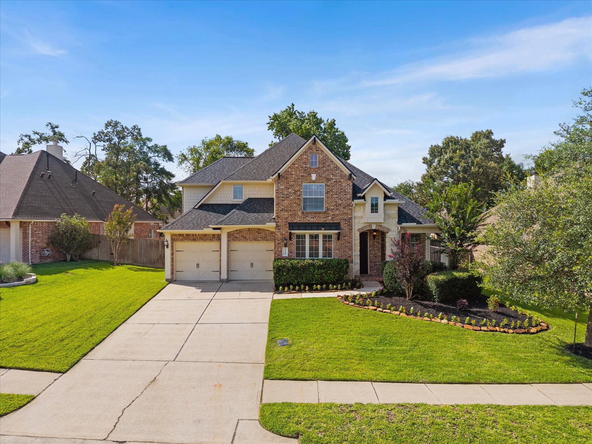 323 Arbor Ridge Lane Conroe, TX 77384 - Photo 1 of 40 Curb appeal that does the talking before you even pull in the driveway. Brick, stone, and a yard that someone has loved. Welcome to 323 Arbor Ridge in Jacob's Reserve. 4 beds, 3.5 baths, and room to breathe. Who's ready to see inside?