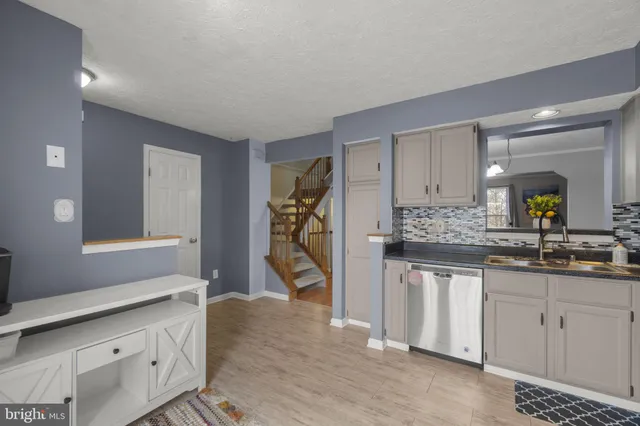 a spacious bathroom with a granite countertop sink and a mirror