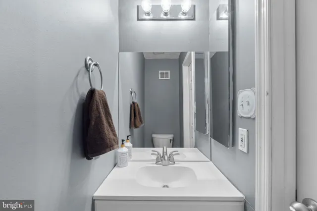 a bathroom with a sink vanity and a mirror
